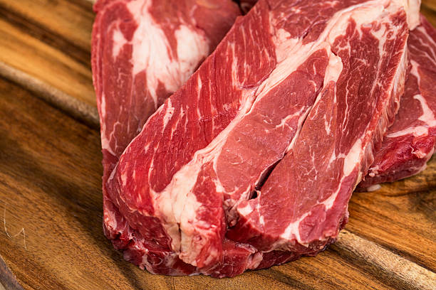 istock Fresh beef steaks on wooden board 469258462