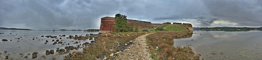 HDR panorama showing medieval St. Nicholas Fortress - Sibenik archipelago, Dalmatia, Croatia. The fortress is one of the most valuable and best preserved examples of defense architecture in Dalmatia.