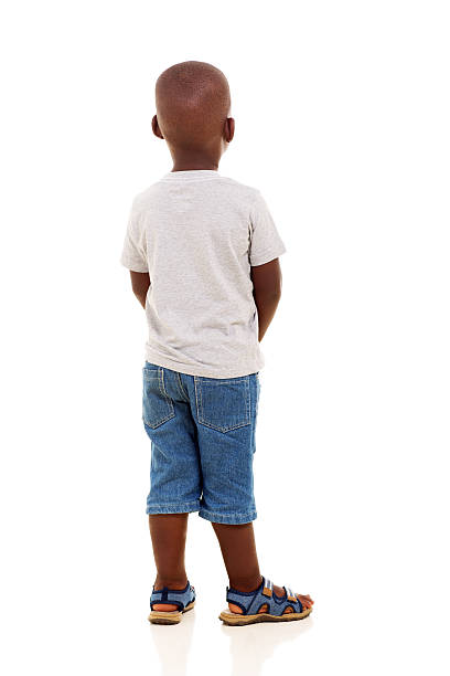 rear view of young african boy isolated on white background