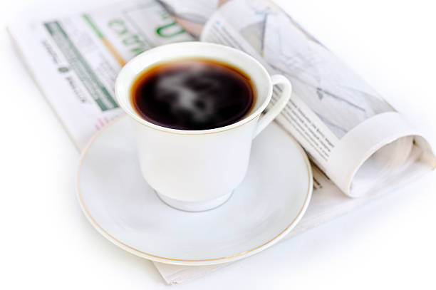 Cup of hot coffee and newspaper