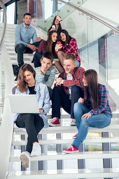 istock Medium group of  students studying on steps of school building. 469275410