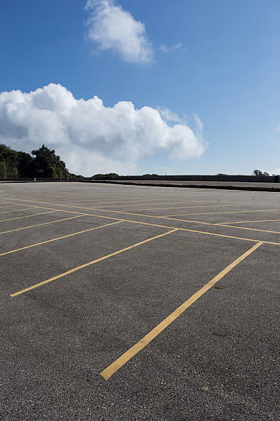istock asphalt roadway with cloud blue sky background 469276258