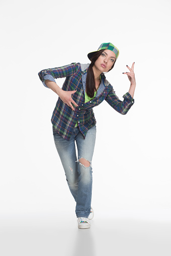 Portrait of street dancer in cap on white background