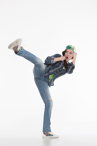 Portrait of street dancer in cap on white background