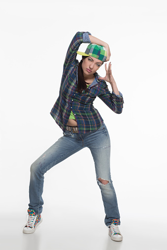 Portrait of street dancer in cap on white background