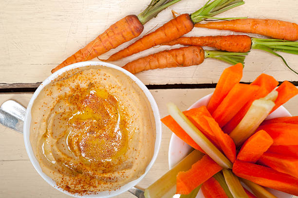 istock fresh hummus dip with raw carrot and celery 469279580