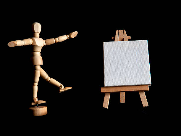 Figurine and Blank Canvas on Easel stock photo