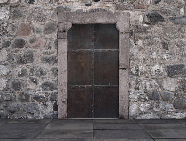 istock Old Metal Door Against a Stone Wall 469283792