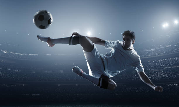istock Soccer player kicking ball in stadium 469287106