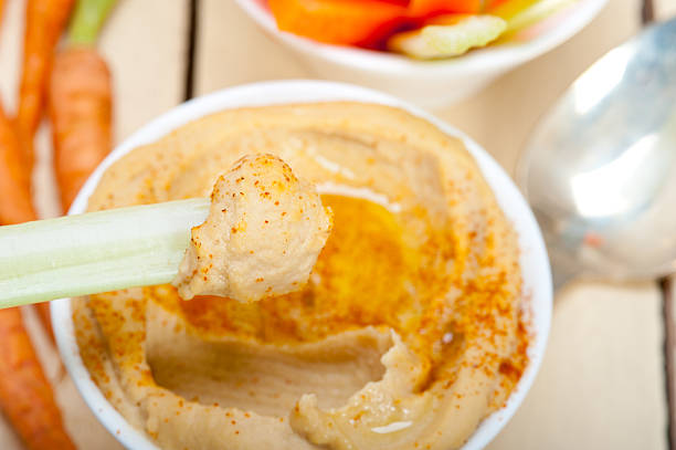 istock fresh hummus dip with raw carrot and celery 469289540