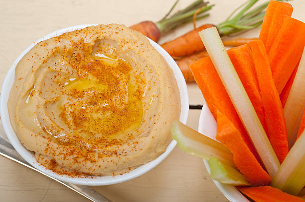istock fresh hummus dip with raw carrot and celery 469289666