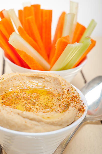 istock fresh hummus dip with raw carrot and celery 469291714