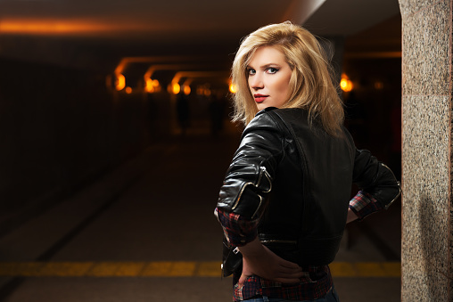 Young fashion blond woman in leather jacket