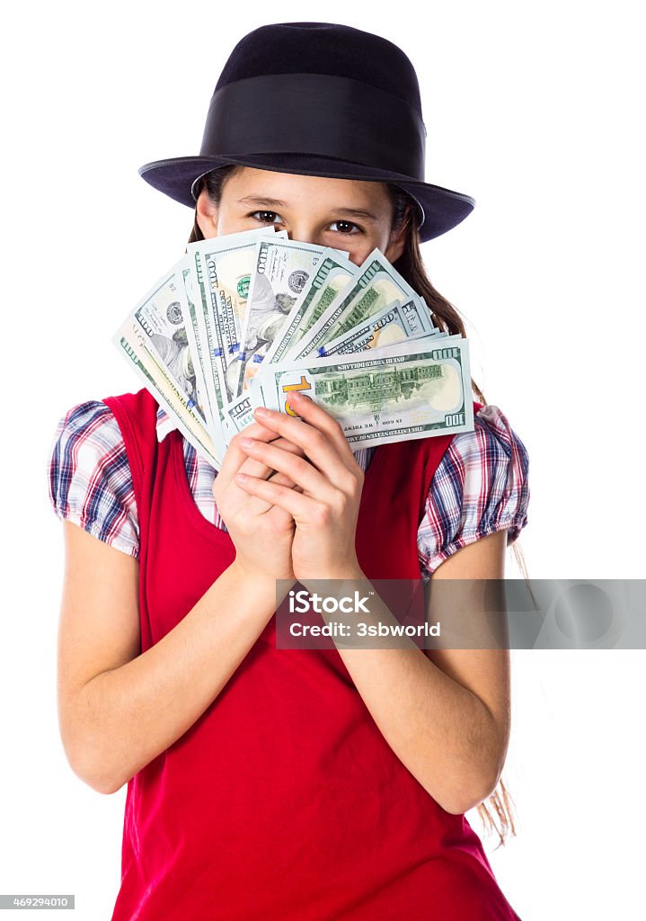 Dreaming girl with money in hands Dreaming girl in black hat hide face in money in hands, isolated on white 2015 Stock Photo