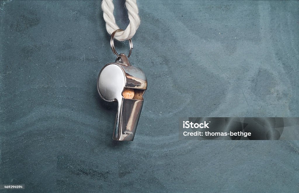 whistle of a soccer referee, whistle of a soccer or football referee hanging on a blackboard, close up shot,free copy space Whistle Stock Photo