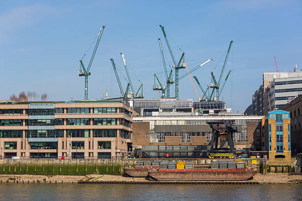 istock Cranes on a building site in London next to Thames 469303112