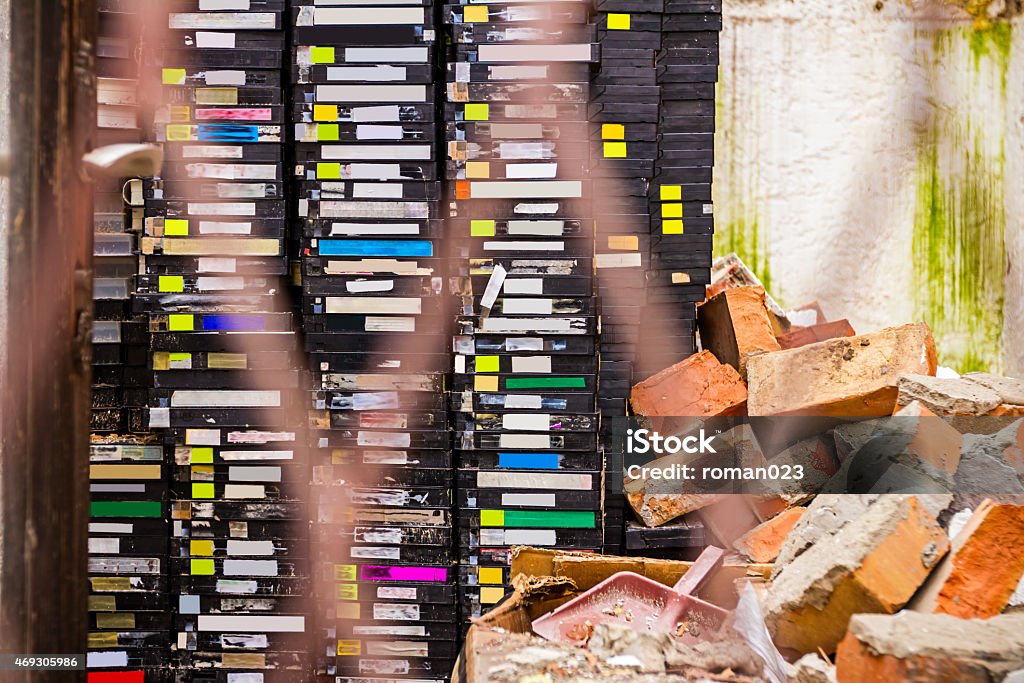 Gone in history Stack of old VHS video cassettes in ruined video store Videocassette Stock Photo