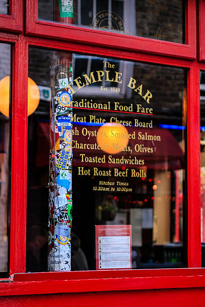 Temple Bar pub Window, Dublin Dublin, Ireland - November 18, 2013: A window of  Temple Bar Pub with details of their offerings, named after Temple Bar, an area on the south bank of the River Liffey in central Dublin, Ireland temple bar pub stock pictures, royalty-free photos & images