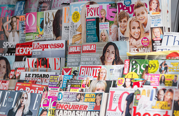 International Magazine Newsstand London, United Kingdom- April 1, 2015: Newsstand found in central London displaying many international titles for sale, featuring UK, US, French and Spanish magazines. Most of the publications are centred on women’s interest, fashion, celebrity gossip or entertainment news. newspaper seller stock pictures, royalty-free photos & images