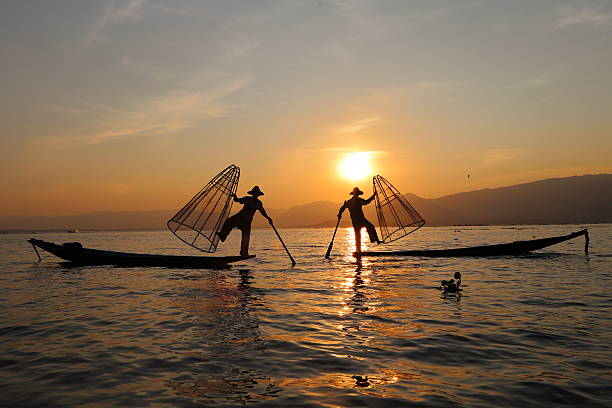 Traditional fishermen at work during the sunset, Myanmar