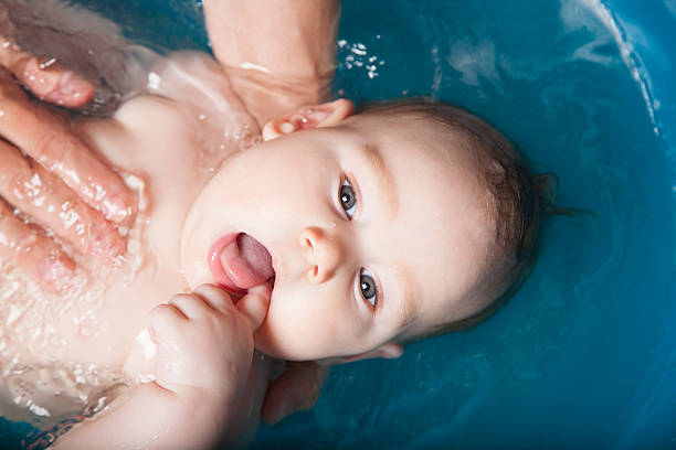istock finger in mouth baby bathing 469310722