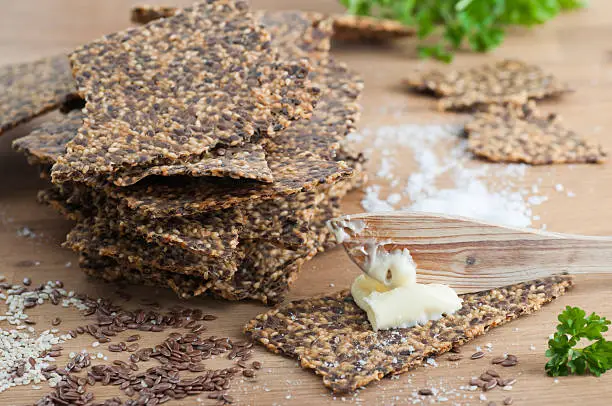 Homemade gluten free flax seed and sesame seed crispbread with butter and sea salt. All organic.