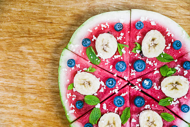 istock Watermelon pizza on wood 469311530
