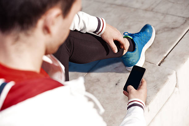 istock athlete typing message on mobile phone 469311542