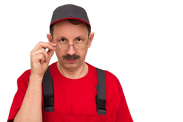 istock Man in red uniform taking off his glasses. 469311798