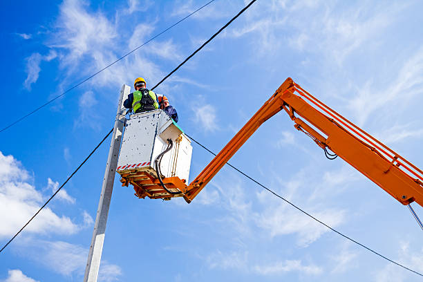 power line team at work on a pole - oppakken stockfoto's en -beelden