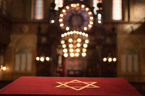 Jewish Temple Magen David The Star of David, known in Hebrew as the Shield of David or Magen David, is the quintessential symbol of Jewish identity. Here embodied in cloth and covering the biome at a wonderful 19th Century Synagogue in Lower East Manhattan. synagogue stock pictures, royalty-free photos & images