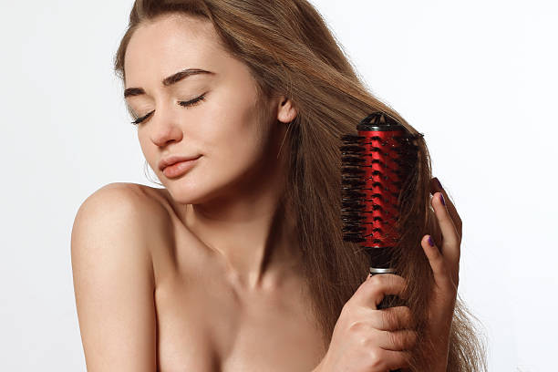 istock young blond woman with comb 469316264