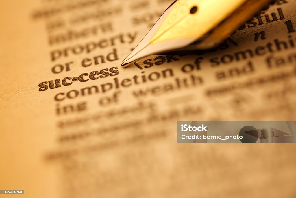 Dictionary Series : Success Success pen nib pointing to the words in the dictionary, shot with very shallow depth of field, 2015 Stock Photo