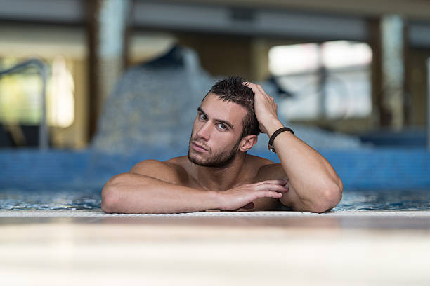 istock Male Swimmer Resting In Pool 469321334