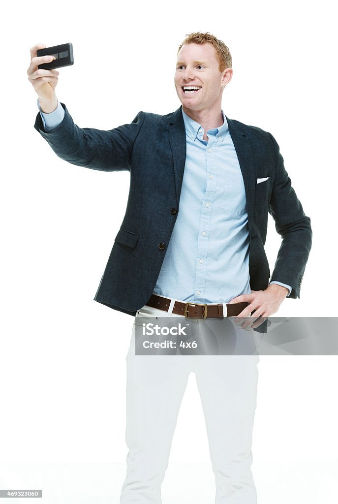 Fashionable male taking a selfie Fashionable male taking a selfiehttp://www.twodozendesign.info/i/1.png Yuppie Stock Photo