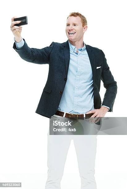 Fashionable Male Taking A Selfie Stock Photo - Download Image Now - Yuppie, Arms Outstretched, Men