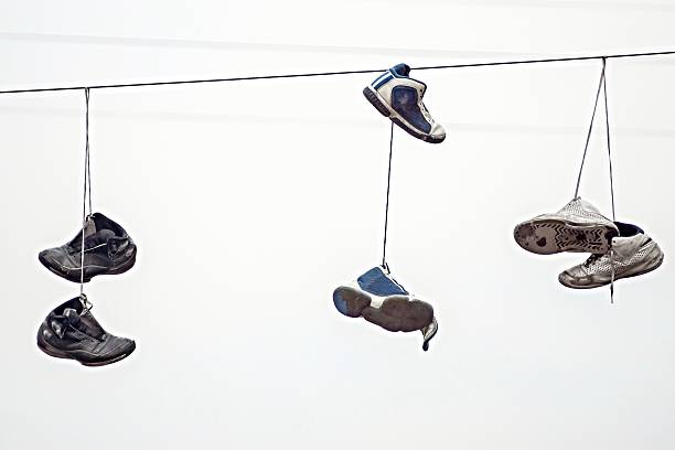 istock three couples old sneakers on wires 469326500
