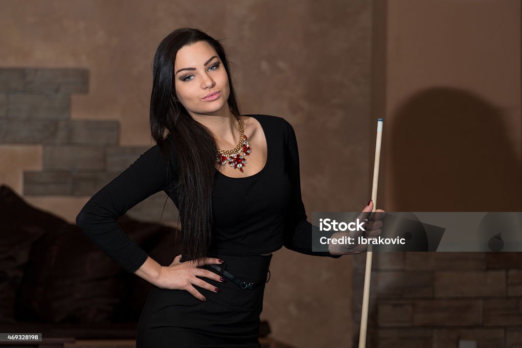 Portrait Of A Young Female Model Playing Billiards Portrait Of A Young Woman Playing Billiards 2015 Stock Photo