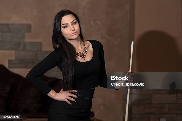 Portrait Of A Young Female Model Playing Billiards Stock Photo - Download Image Now - 2015, Adult, Adults Only