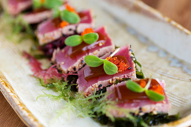 a delicious platter of tuna tataki - sashimi stok fotoğraflar ve resimler
