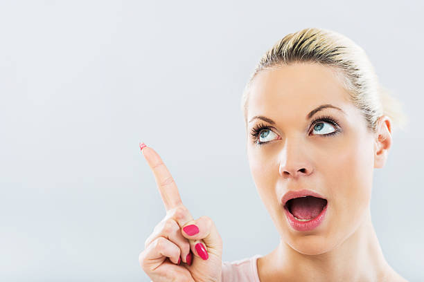 istock Surprised woman pointing up. 469329134