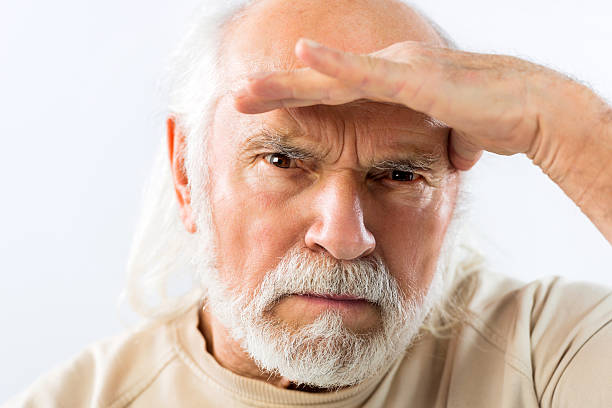 istock Senior man looking at camera with a hand on forehead. 469329226