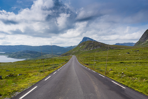 A long stretch of asphalt in the high Mountain Range of Jotunheiman National Park, Sogn Og Fjordane, Norway. One of the most beautiful Scenic Routes in Norway.