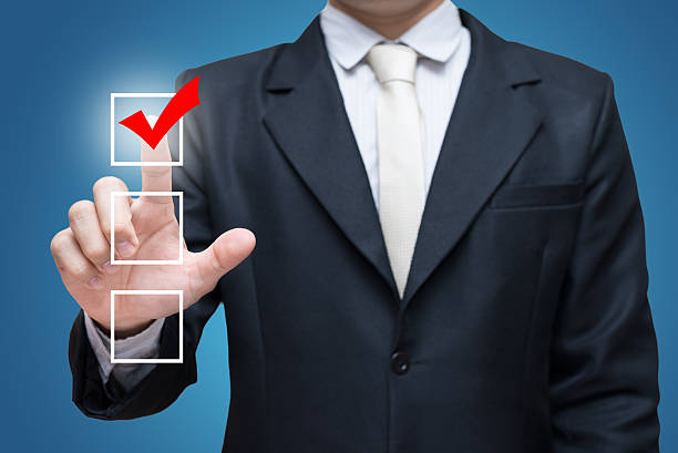 istock Businessman touch checking mark checklist marker Isolated on blue background 469333390