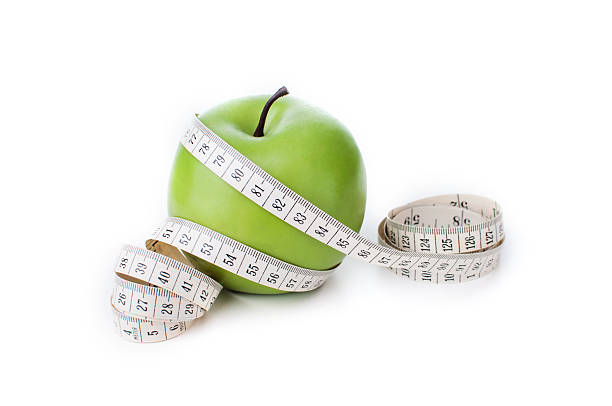 istock Green apple with measuring tape 469333798