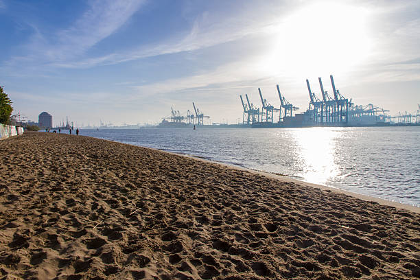 Long view of Elbe und Container Hafen in Hamburg Container bridges on the Elbe in the Port of Hamburg in the morning hours shortly after sunrise. elbe river stock pictures, royalty-free photos & images