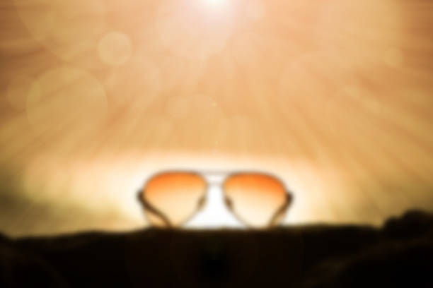 istock Sunglasses at Sunset and Rays of Sunlight 469347672