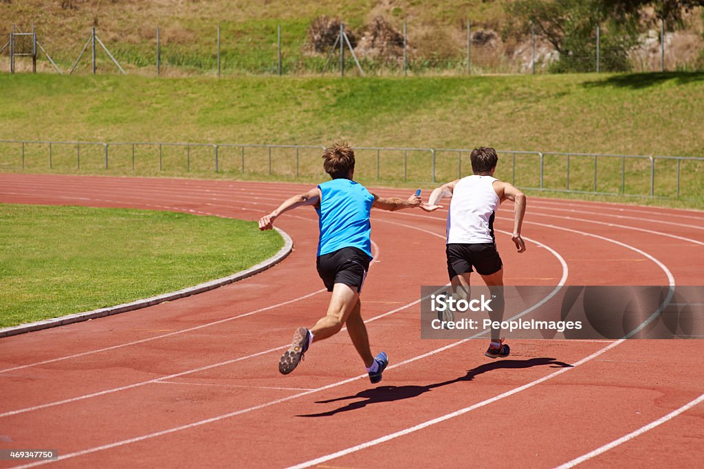 Doing it for the team Rearview shot of two athletes running in a relay racehttp://195.154.178.81/DATA/i_collage/pi/shoots/783737.jpg 2015 Stock Photo