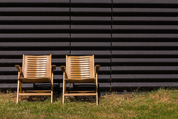 istock Old plywood chairs in the sun 469351156