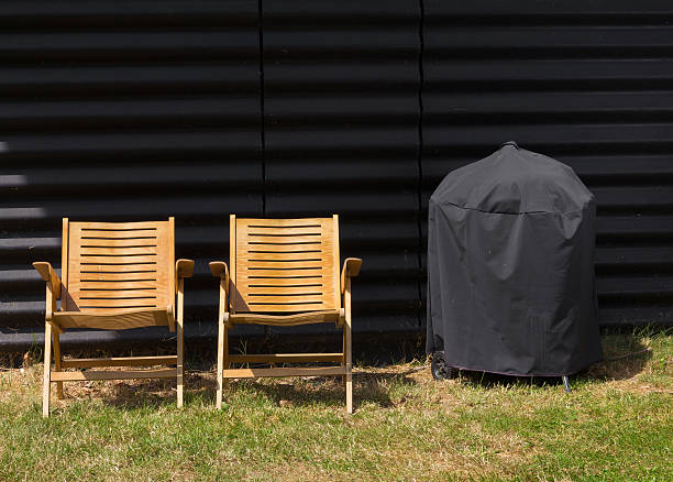 Two chairs and a covered grill stock photo